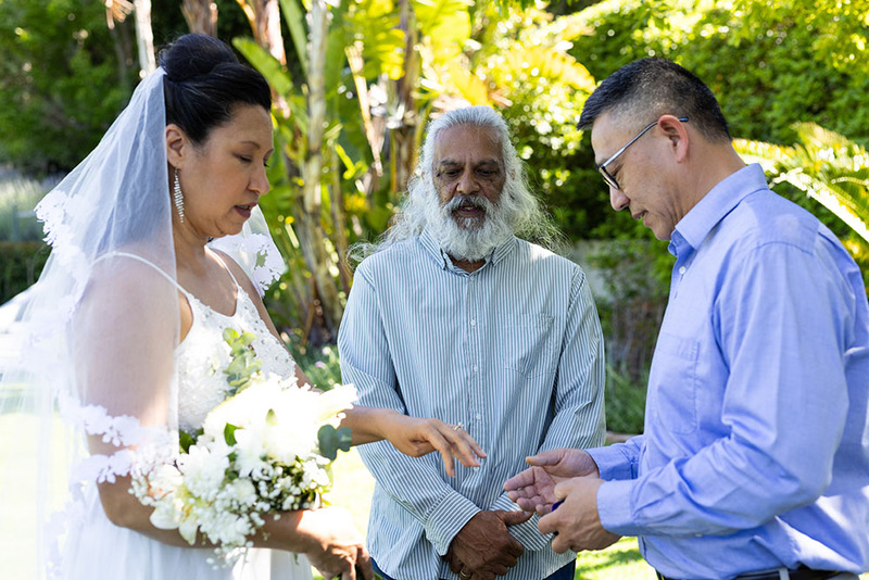 wedding officiant performs outdoor wedding ceremony for bride and groom