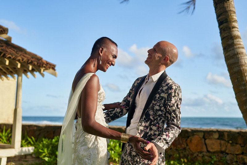 Happy LGBTQ+ couple on the wedding day pose for photos outside