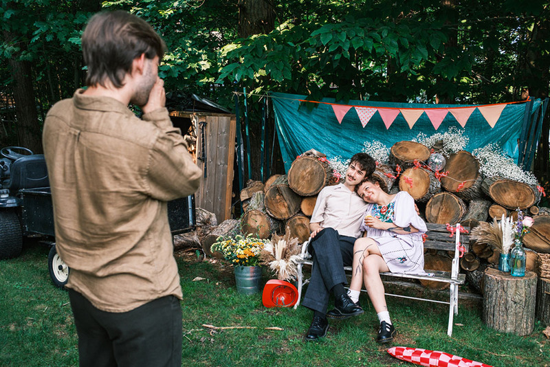 Young newlyweds pose for photo after outdoor wedding / reception
