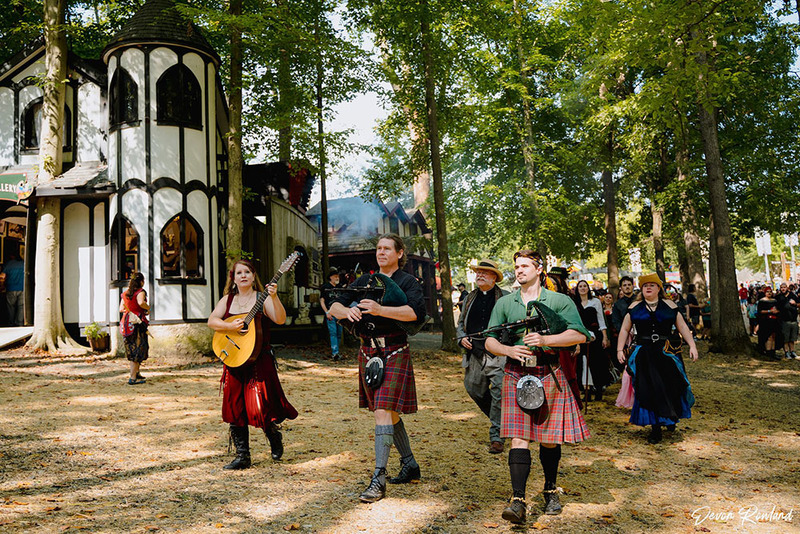 Musicans lead the wedding procession at an outdoor ren fest wedding
