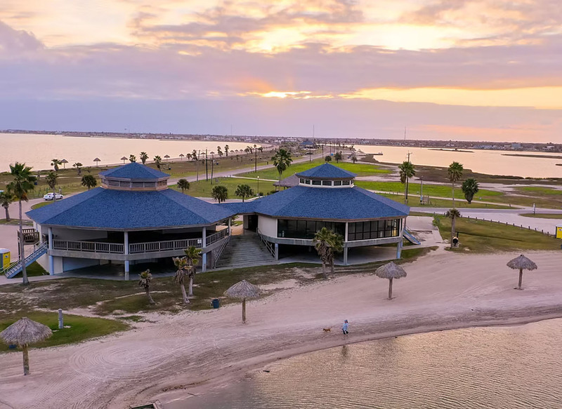 Aerial view of the Rockport Beach Pavilions, two large octagon shaped buildings along the beach