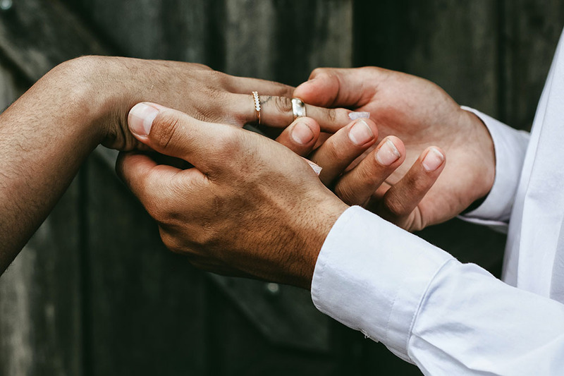 Close up bride and groom exchanging rings