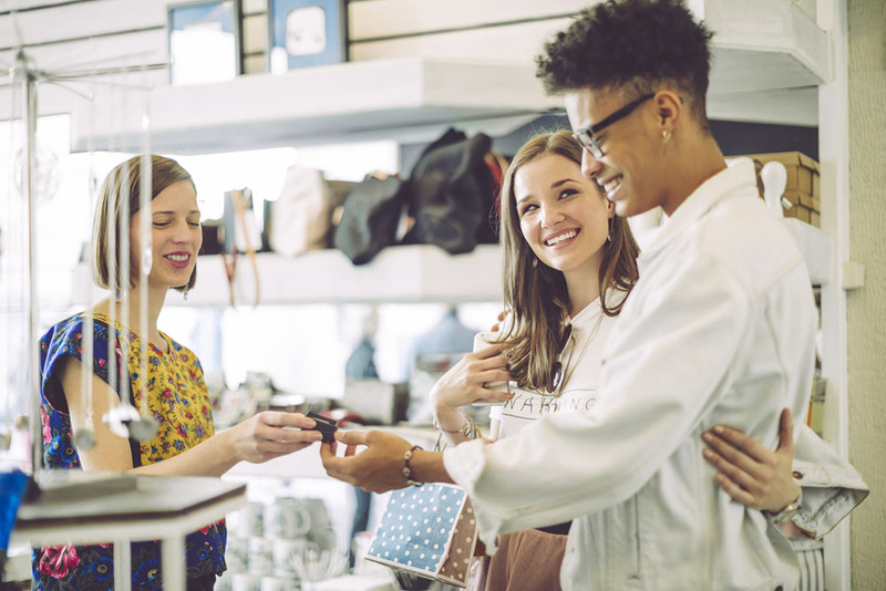 Young couple shopping for engagement ring at shop