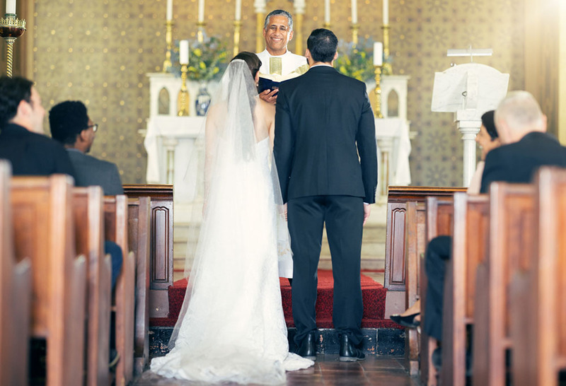 Bride and groom standing with their backs to the guests