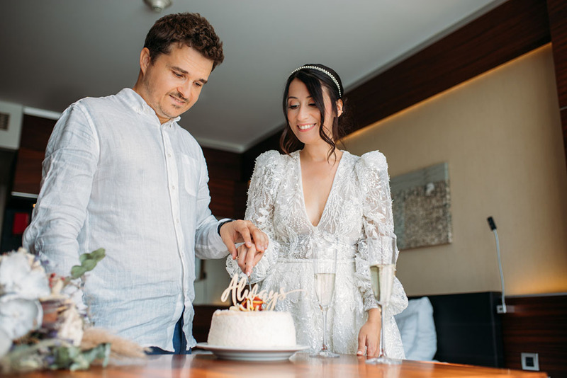 Groom and bride cut wedding cake in private ceremony