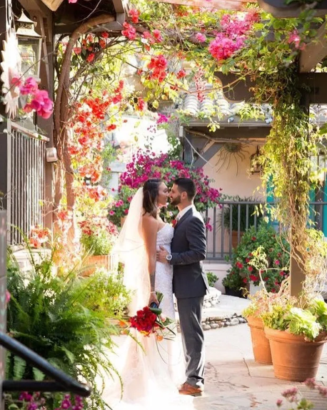 bride and groom posing near flowers at Seven 7 Seven wedding venue 