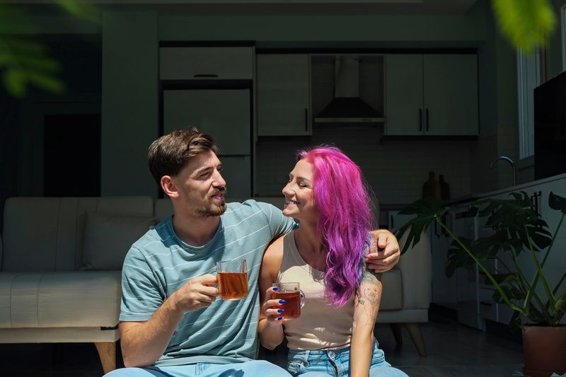 Young couple sips mead on their porch