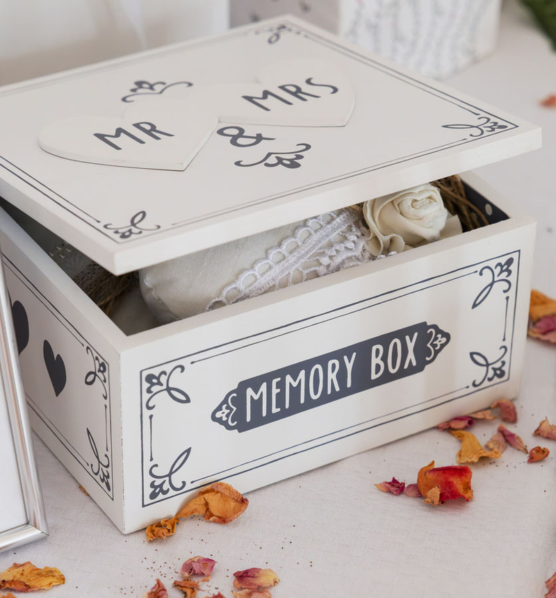 A white wooden box labeled "mr & mrs" on the top and "memory box " on the side for wedding keepsakes