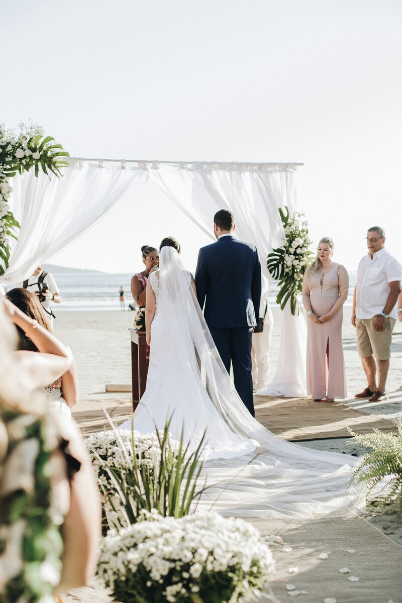 Officiant performs outdoor beach wedding