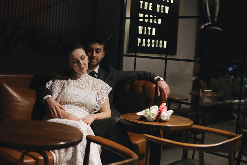 Romantic couple relaxing at a cafe on wedding day