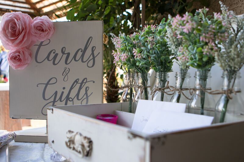 close up of a sign that reads 'cards & gifts' decorated with roses for a wedding gift table
