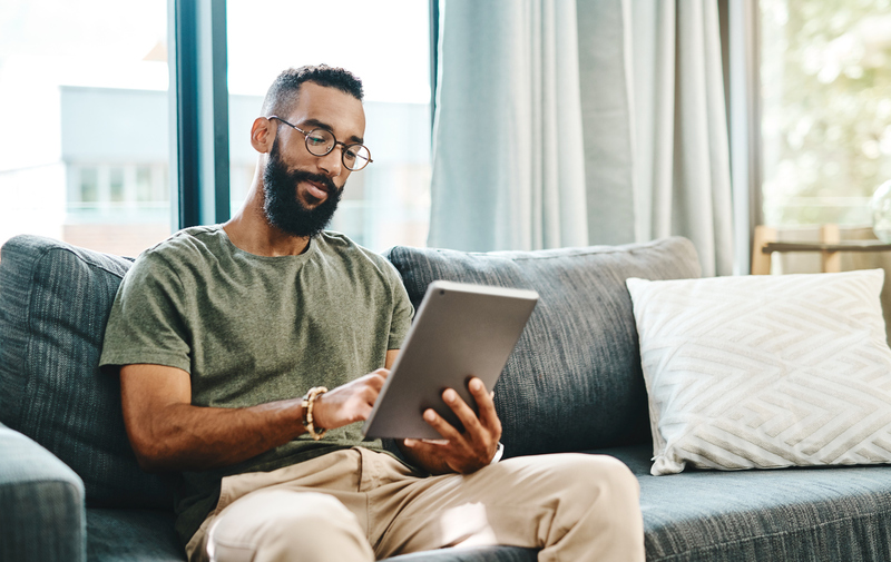 man using tablet to get ordained online with AMM