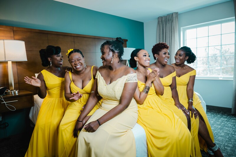 bride and bridesmaids laughing together before wedding