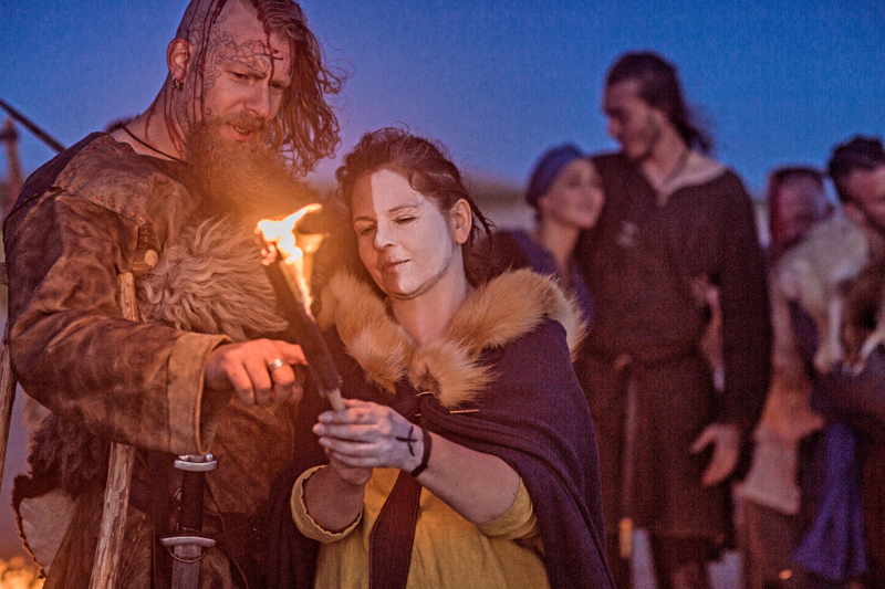 Modern heathen wedding ceremony, viking wedding ceremony, with a large bearded man and woman holding fire