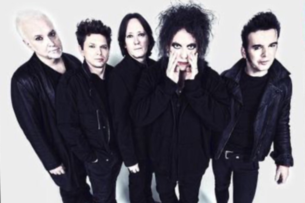The Cure band photo, wearing all black against a white background
