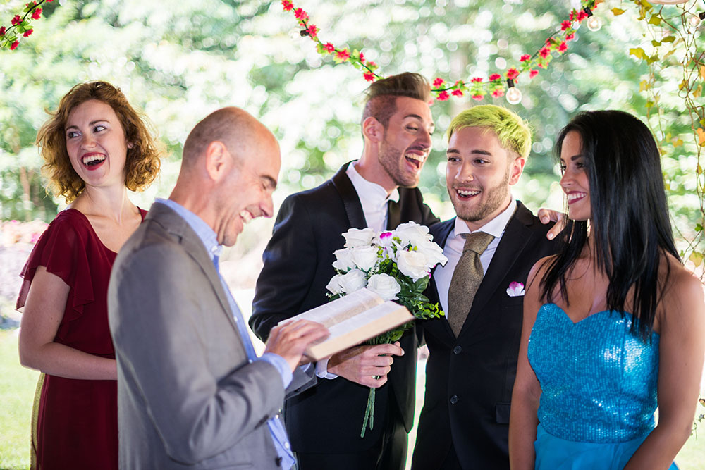 Does the officiant get a wedding invitation? And do they stay for the reception or afterparty? Keep reading for our simple advice on wedding invite etiquette! (Photo: ilbusca / iStock)