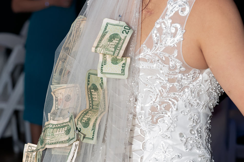 Money pinned to a bride's veil 