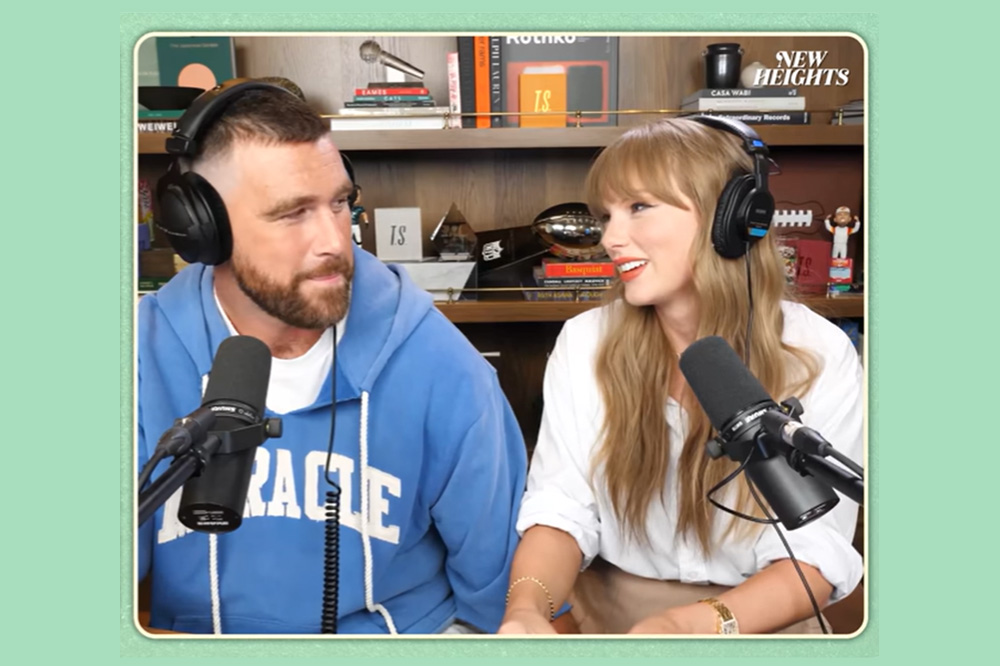 Travis Kelce and Taylor Swift talk together during an episode of the New Heights sports podcast