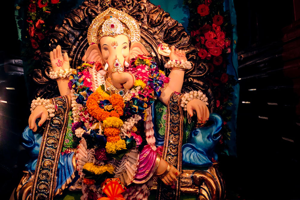 Above:  Lord Ganesha, remover of obstacles and Hindu god of new beginnings, is often prayed to during wedding ceremonies, including the symbolic Kadali Vivah to counter the Manglik Dosah.  (Photo cropped: Cr8ive_Omi / iStock)