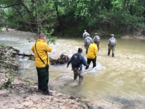 Fort Hood DES and Texas Task Force One search and rescue personnel coordinate their search efforts at the staging area on Turkey Run Road April 12 looking for Fort Hood's missing person. (U.S. Army photo by Master Sgt. Mary Mittlesteadt)