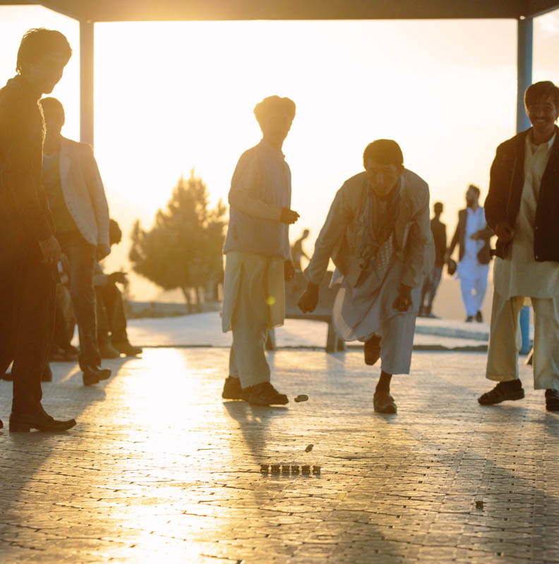 Men playing a game as the sun sets