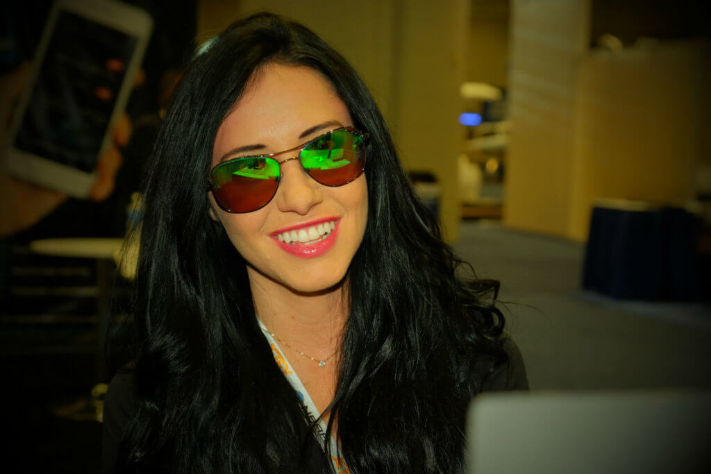 Tracy Maloney, sales coordinator for ST Laserstrike, models glasses that block out the majority of light from green and blue lasers, as well as infrared and ultraviolet light.