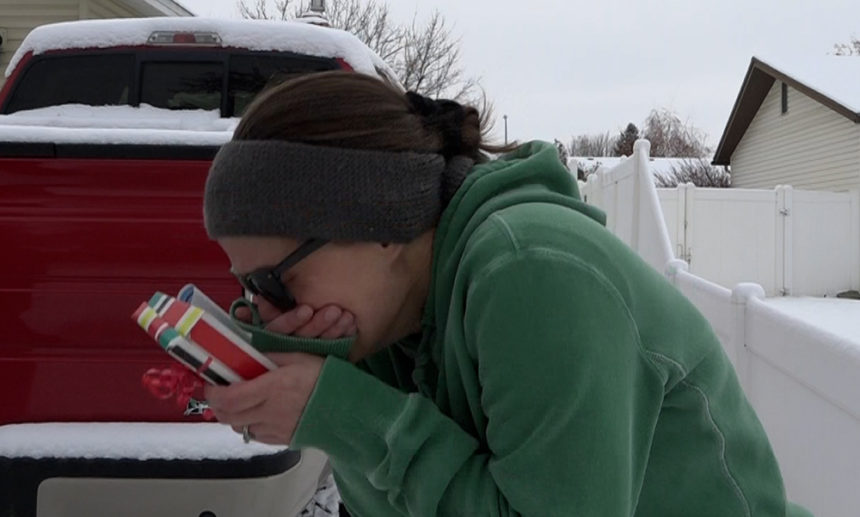 woman sobs driveway