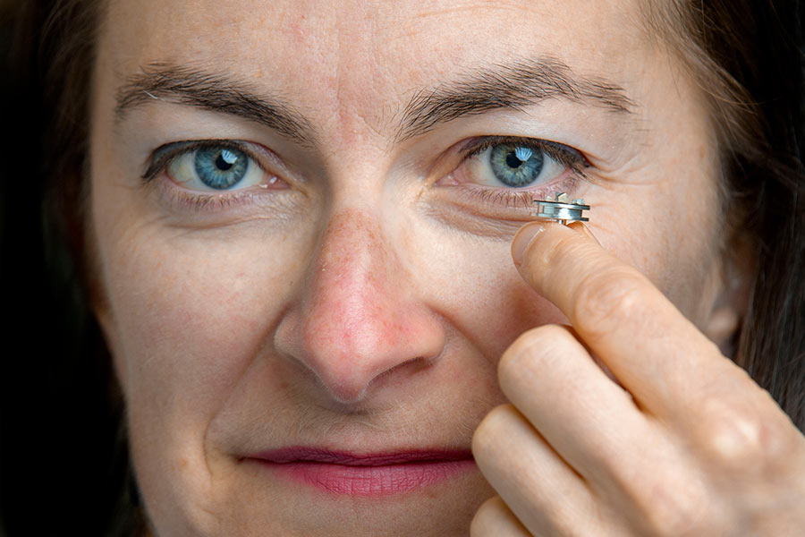 Maria McNamara holds a sample of the tiny pterosaur feathers.