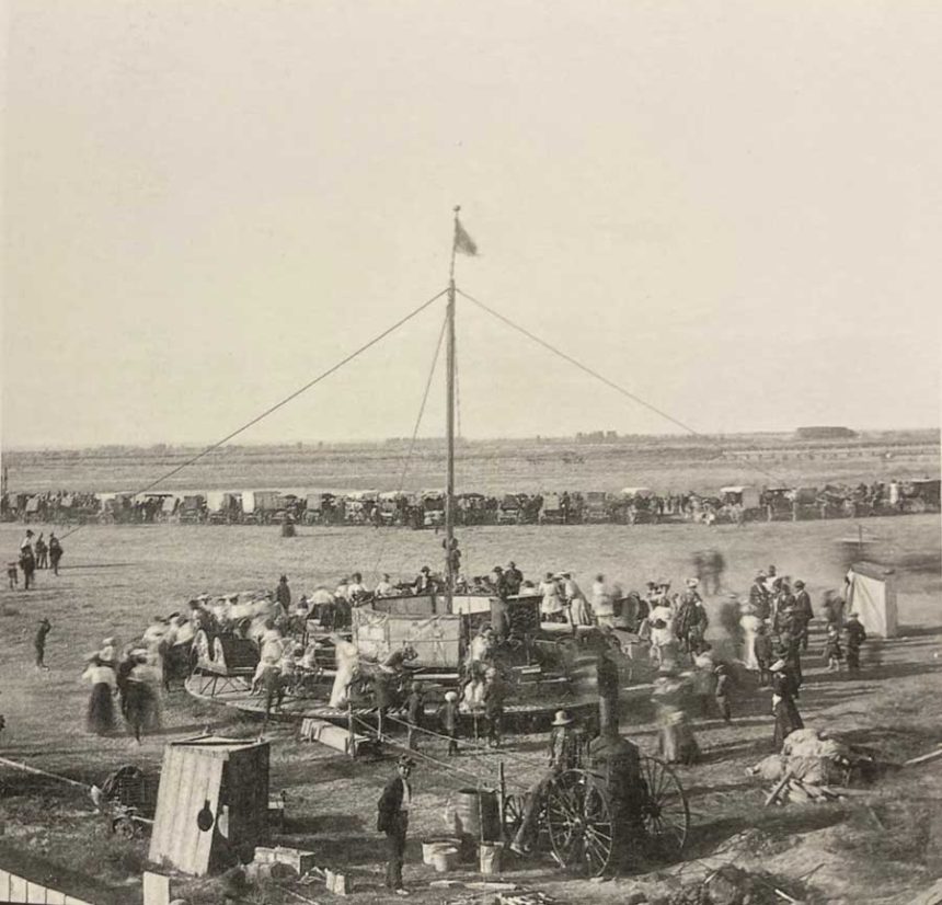 A very old merry-go-round full of people at the Eastern Idaho State Fair in Blackfoot, Idaho, in 1907.