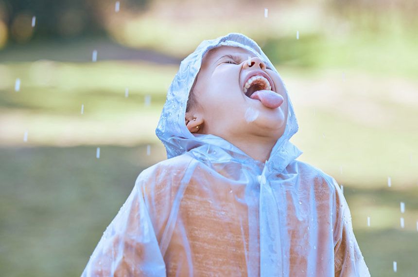 child drinking raindrops