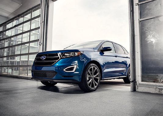 Blue vehicle entering a service garage