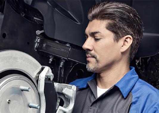 Person servicing the brakes of a vehicle