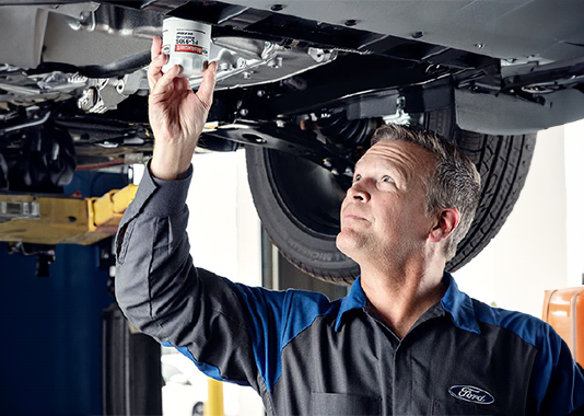 Person servicing a vehicle on a lift