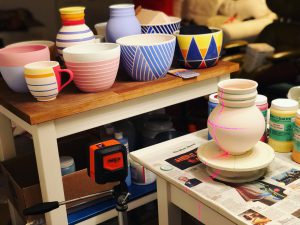 a-collection-of-jason-fox-ceramics-brightly-colored-ceramics-ceramics-being-glazed