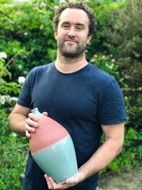 jason-fox-of-jason-fox-ceramics-holding-one-of-his-pieces