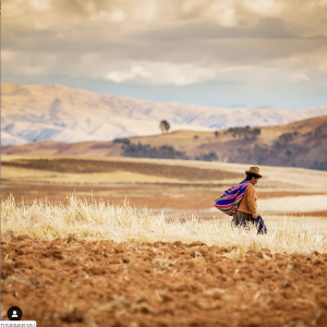 indigenous-woman-wearing-traditional-hat-strolling-the-hillsides-of-the-sacred-valley