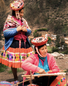 indigenous-women-wearing-ttraditional-garb-women-wearing-colorful-cultural-clothing-while-weaving