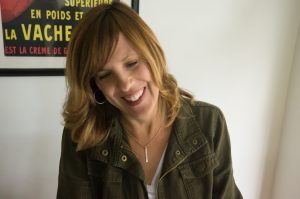 sudsource-founder-kathleen-oclock-in-her-office-kathleen-smiling-and-working