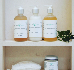 sudsource-products-displayed-on-shelf-sudsource-shampoos-and-conditioner-on-bathroom-shelf