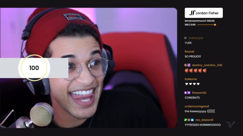 Jordan Fisher smiles in red beanie after stream donation