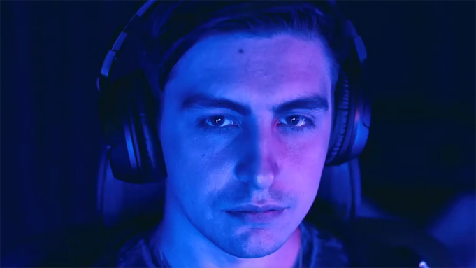 Shroud gamer wearing headset in dark room with blue Mixer lighting