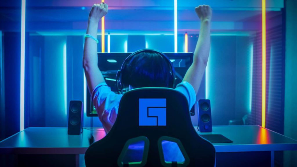 Gamer raises arms in victory sitting in facebook gaming chair