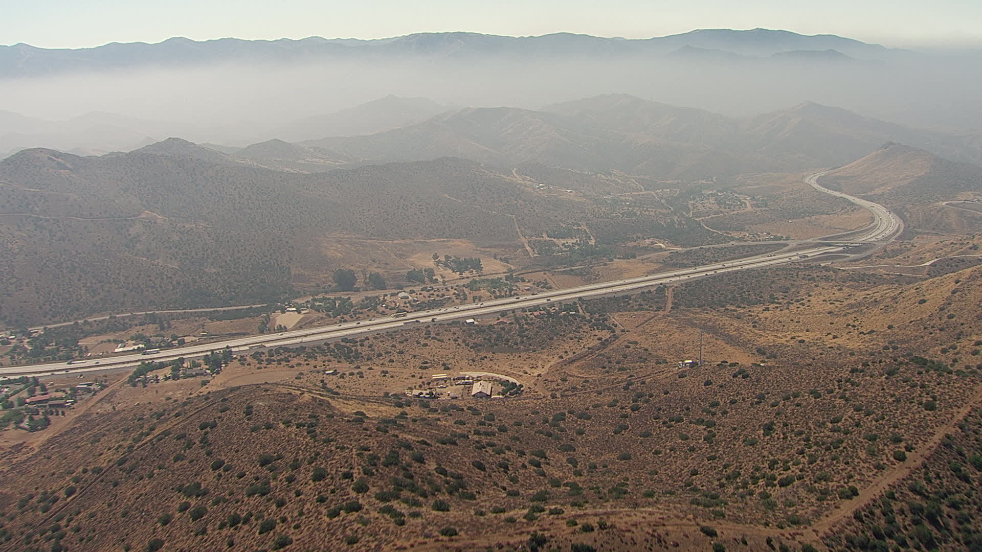 HD stock footage aerial video fly over hills to approach and pan across