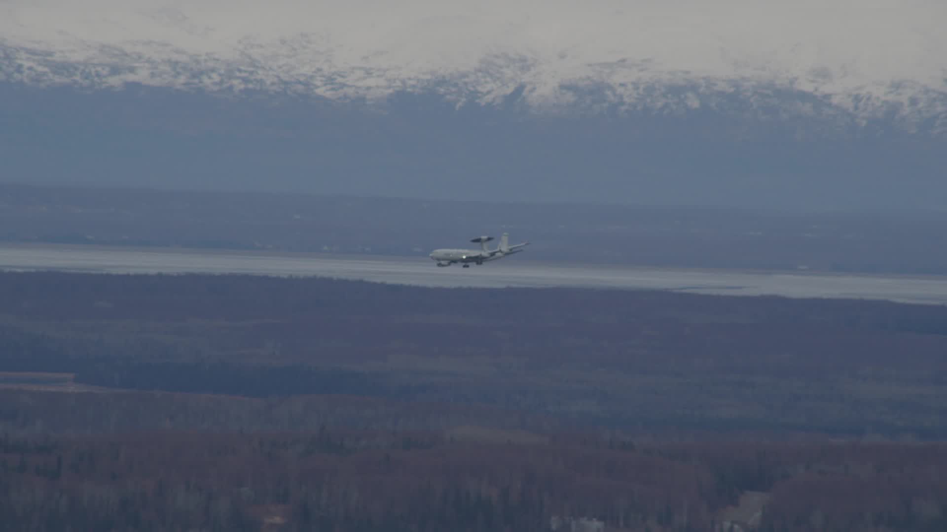 4K stock footage aerial video tracking E3 Sentry landing, snowy