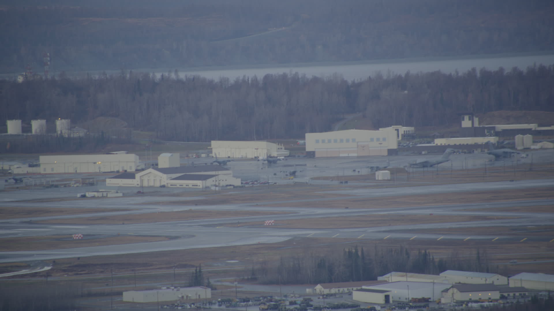 4K stock footage aerial video a view of hangars, aircraft in winter