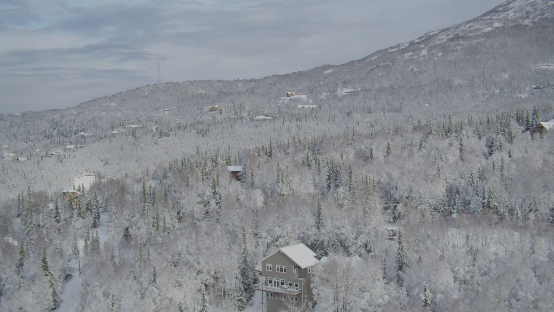4K stock footage aerial video homes on snowcovered wooded slope, Eagle