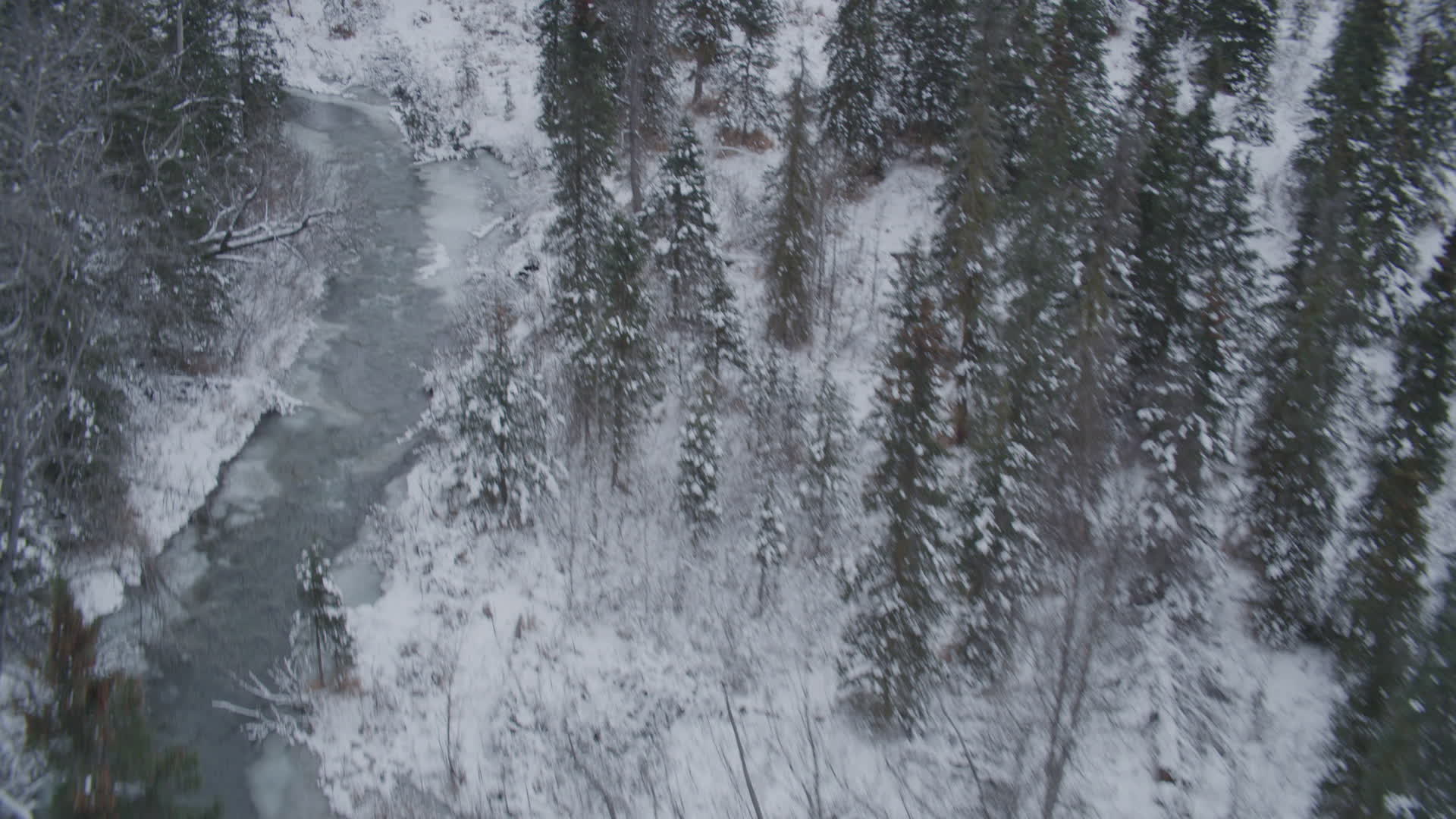 4K stock footage aerial video flying low over river through snow