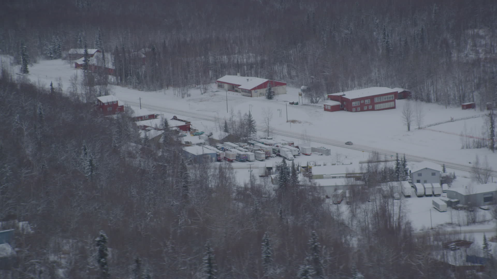 4K stock footage aerial video snow covered shops on Old Glenn Highway