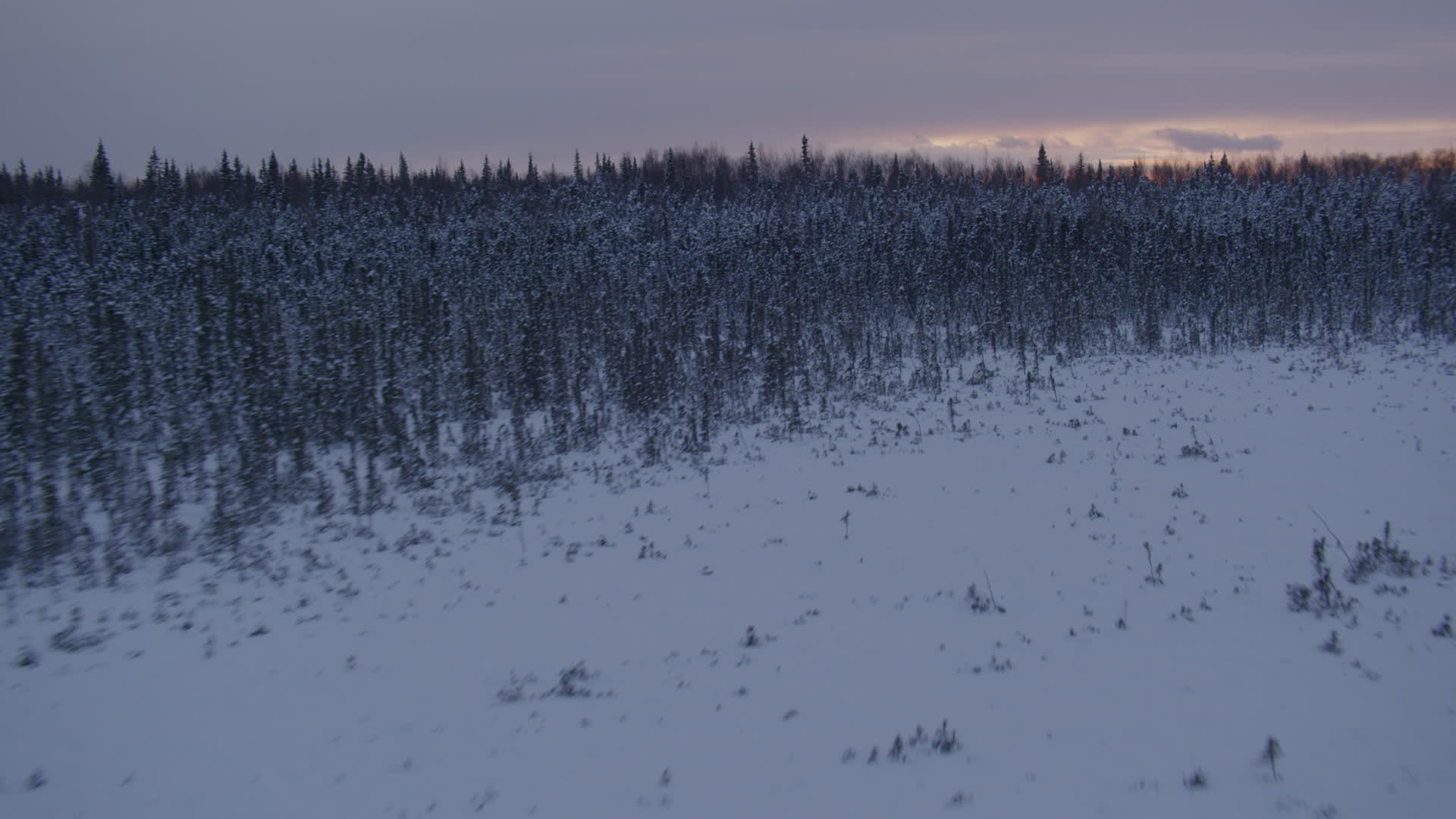 4K stock footage aerial video flying low over frozen, snowy ground at