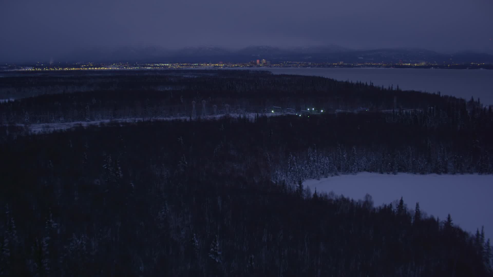 4K stock footage aerial video revealing Downtown Anchorage skyline, winter, Point MacKenzie